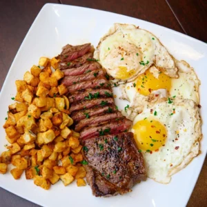 steak eggs and crispy fried potatos